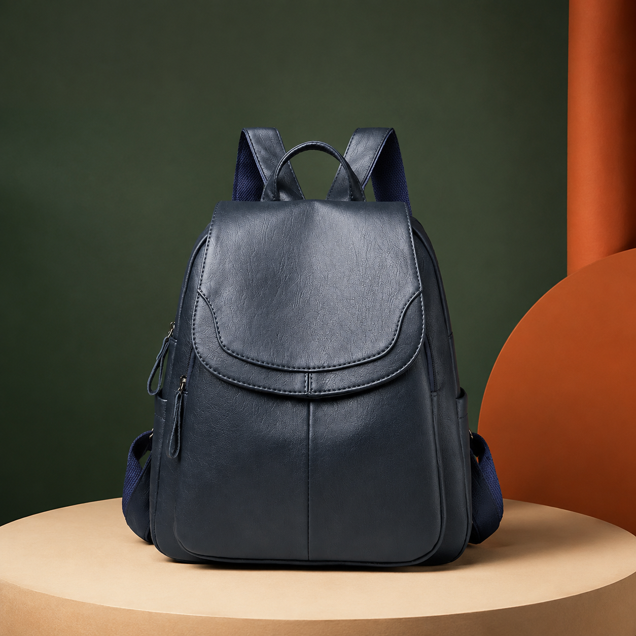 Navy womens backpack on a warm ivory backdrop