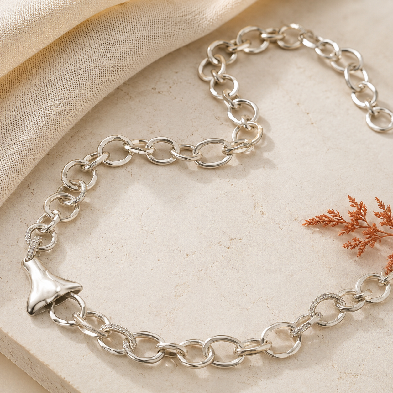 Elephant pendant necklace on warm ivory linen