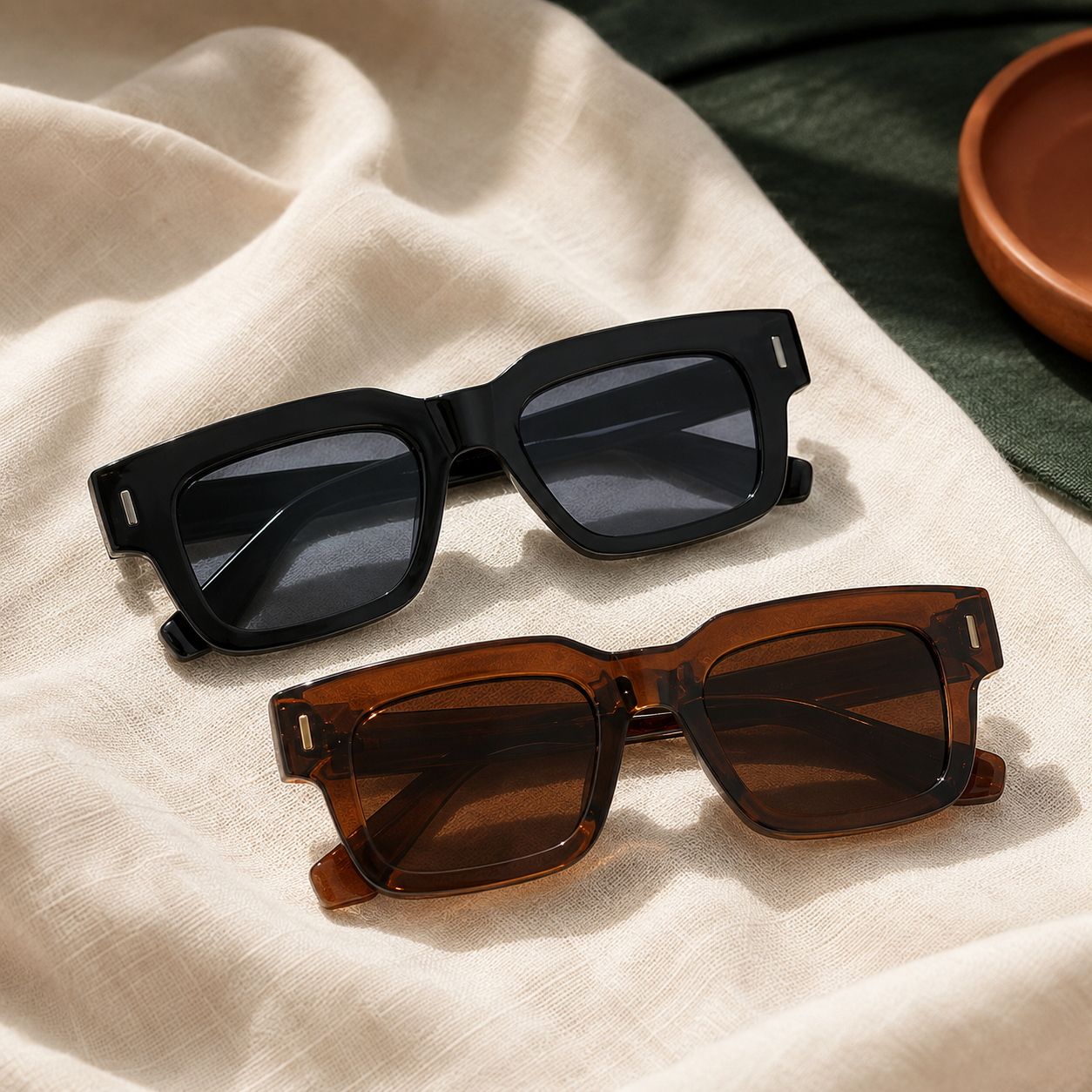Black and brown rectangular sunglasses on ivory linen