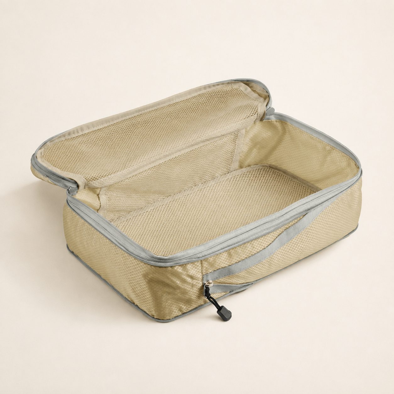 Largest beige compression cube open with the lid folded back to show the mesh interior